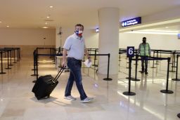 U.S. Senator Ted Cruz (R-TX) carries his luggage at the Cancun International Airport before boarding his plane back to the U.S., in Cancun, Mexico February 18, 2021.
