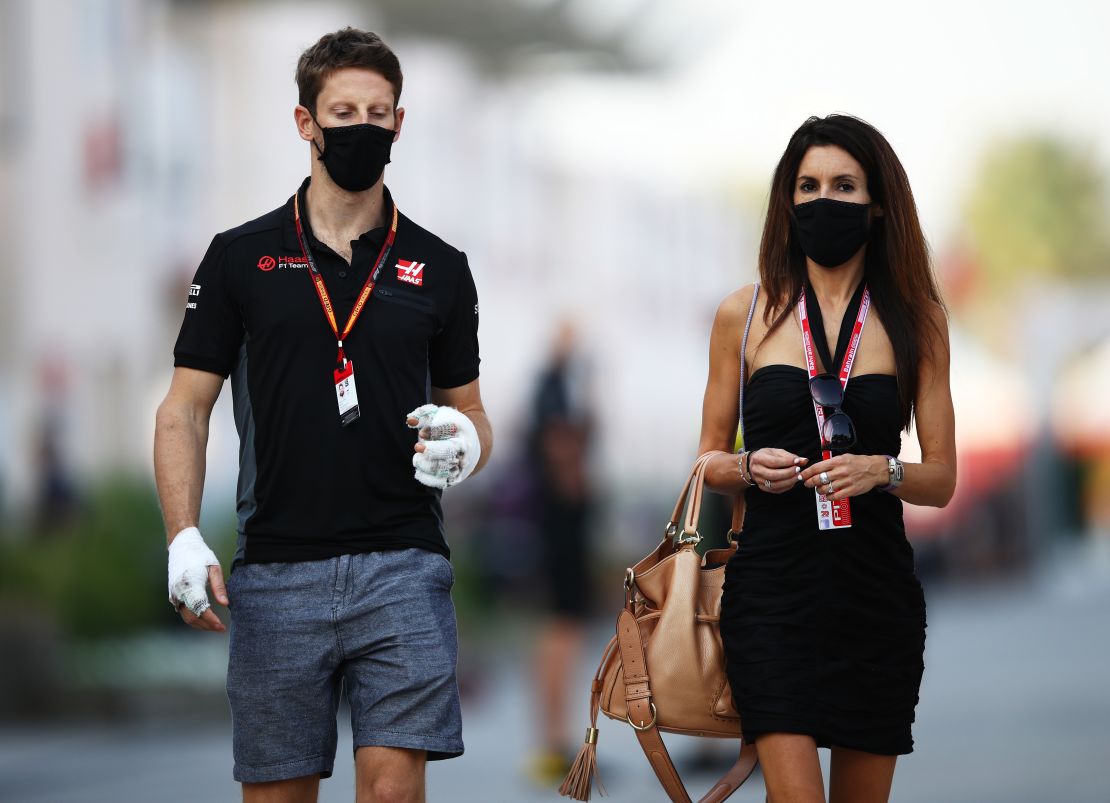 Grosjean and his wife Marion walk in the paddock ahead of the Sakhir Grand Prix in Bahrain.