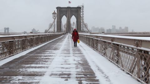 The Brooklyn Bridge was a lonely place Thusday as snow fell in New York.