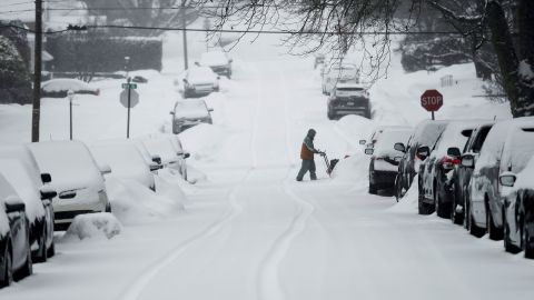 A man uses a snowblower Thursday morning at an intersection in Reading, Pennsylvania.