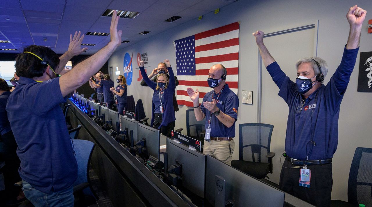 Members of NASA mission control celebrate after receiving confirmation that the rover successfully touched down on Mars on February 18.