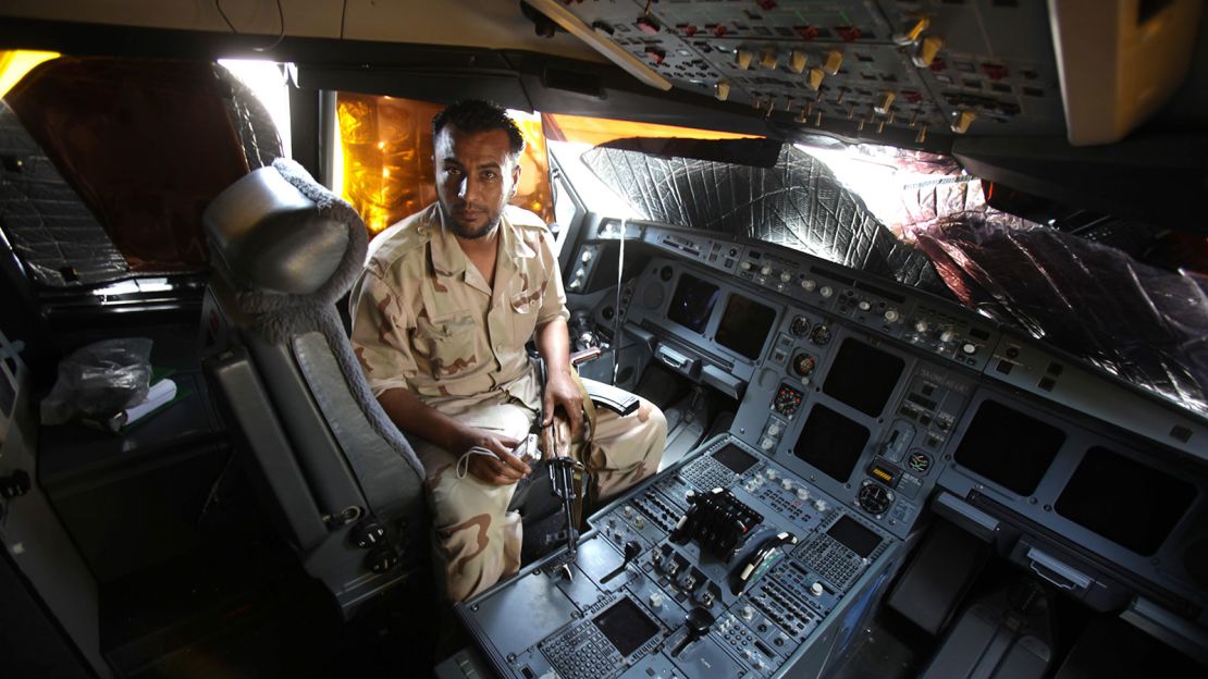 In August 2011, a Libyan rebel sits in the cockpit of the A340 that already had amassed a colorful history.
