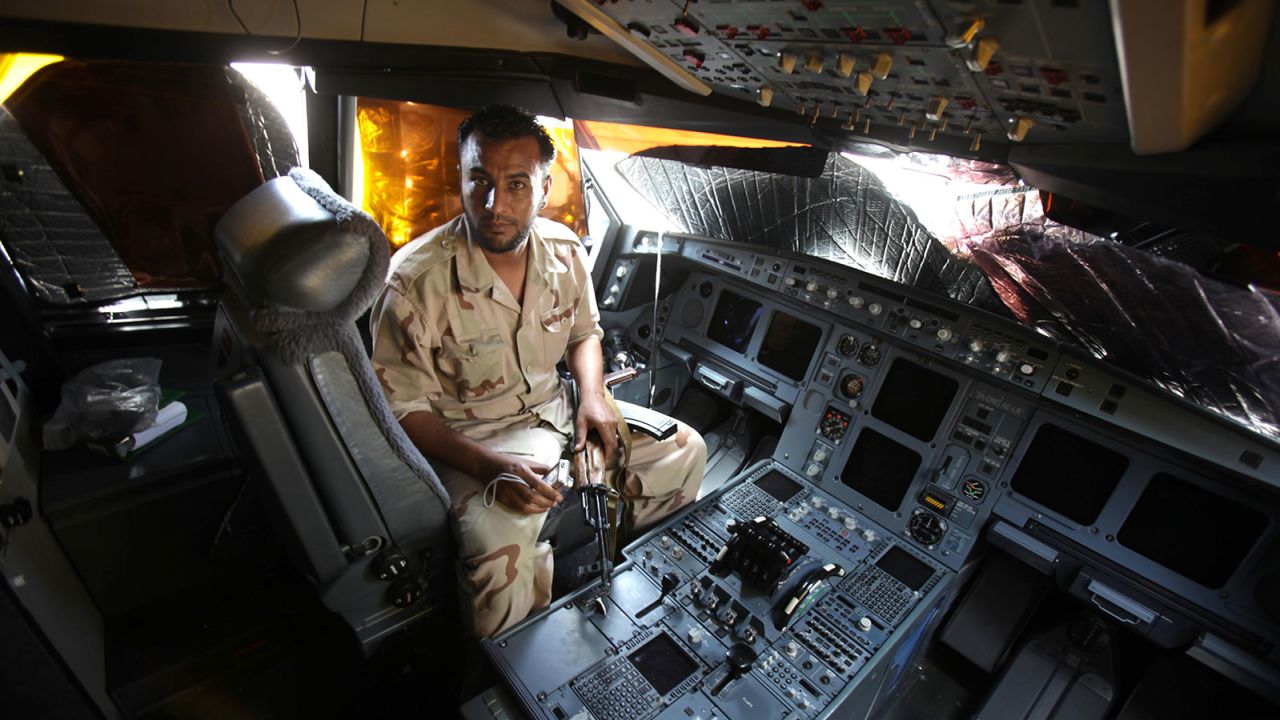 In August 2011, a Libyan rebel sits in the cockpit of the A340 that already had amassed a colorful history. 