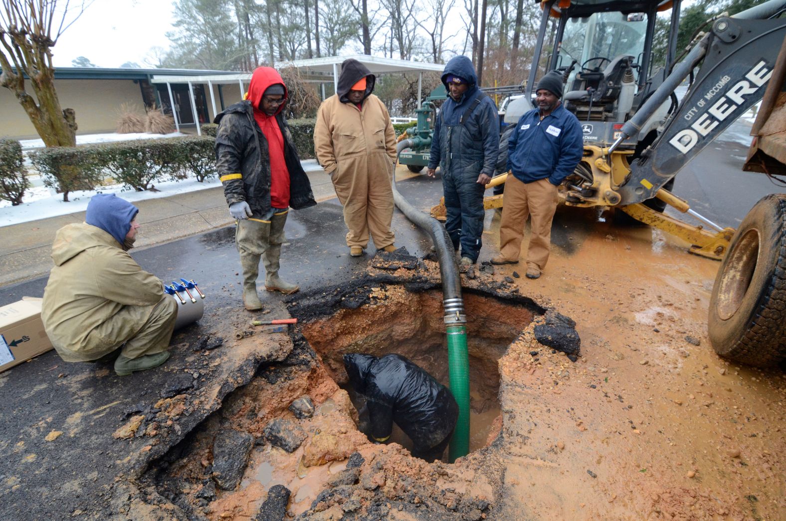 City workers repair a busted water main in McComb, Mississippi, on Thursday.