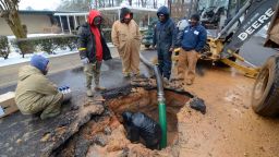 City workers repair a busted water main in McComb, Miss., on Thursday, Feb. 18, 2021.  Winter storms that dumped additional snow and ice on the Deep South plunged thousands of homes and businesses into darkness and left roads impassable across a wide area.  (Matt Williamson/The Enterprise-Journal via AP)