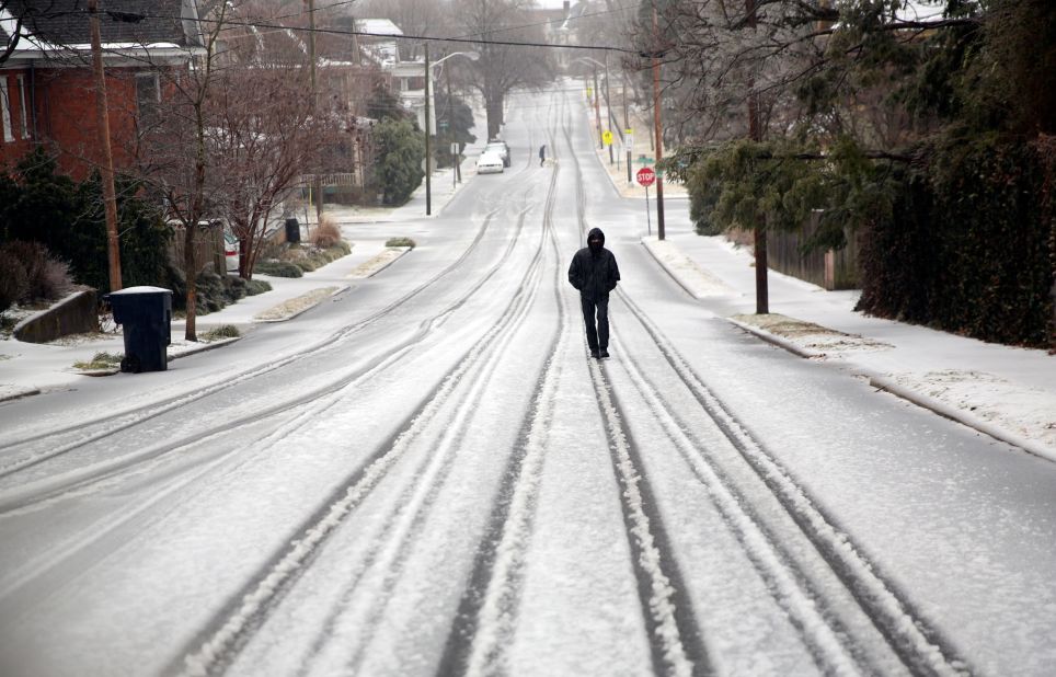 Emanuale Small walks up to a bus station in Roanoke, Virginia, on Thursday. Small had to make it to a doctor's appointment, and he was told they would push the time back a little for him so he could still make it despite the icy conditions.