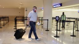 U.S. Senator Ted Cruz (R-TX) carries his luggage at the Cancun International Airport before boarding his plane back to the U.S., in Cancun, Mexico February 18, 2021. REUTERS/Stringer NO RESALES. NO ARCHIVES. BEST QUALITY AVAILABLE     TPX IMAGES OF THE DAY