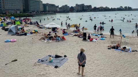 A general view shows beachgoers at Hamdeok beach on South Korea's southern resort island of Jeju on August 24, 2020. (Photo by Daniel De Carteret/AFP via Getty Images)