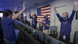 Members of NASA's Perseverance rover team react in mission control after receiving confirmation the spacecraft successfully touched down on Mars, Thursday, Feb. 18, 2021, at NASA's Jet Propulsion Laboratory in Pasadena, California. A key objective for Perseverance's mission on Mars is astrobiology, including the search for signs of ancient microbial life. The rover will characterize the planet's geology and past climate, pave the way for human exploration of the Red Planet, and be the first mission to collect and cache Martian rock and regolith. Photo Credit: (NASA/Bill Ingalls)
