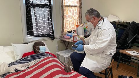 Dr. Steven Landers, president and CEO of the Visiting Nurse Association Health Group, administers the Covid-19 vaccine to Sam Ferguson of Asbury Park, New Jersey.  