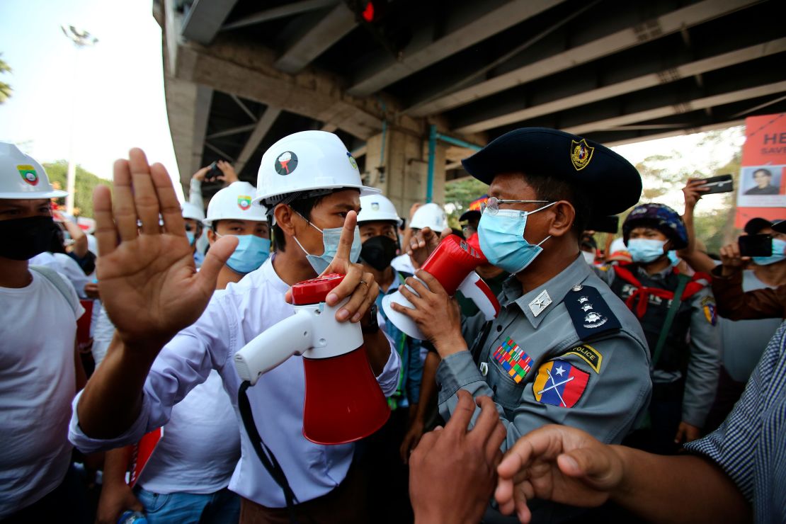 A protester speaks to a police officer during an anti-coup rally outside the Hledan Centre in Yangon, Myanmar on February 19.
