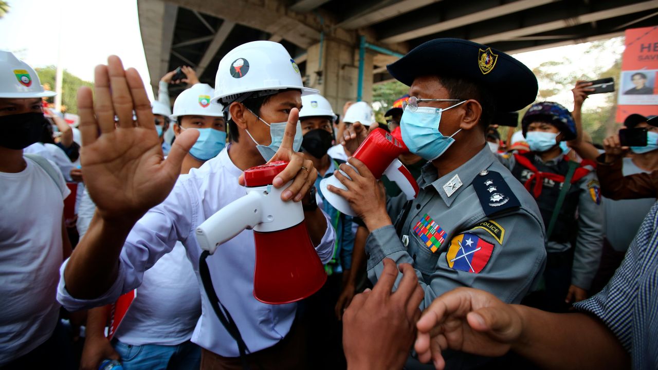 A protester speaks to a police officer during an anti-coup rally outside the Hledan Centre in Yangon, Myanmar on February 19.