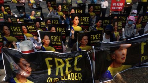 Protesters hold up signs demanding the release of detained Myanmar leader Aung San Suu Kyi outside the French Embassy in Yangon on February 19.
