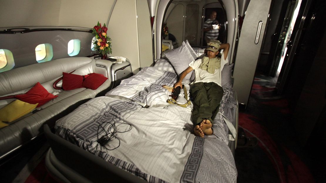 A Libyan rebel relaxes in the plane at Tripoli in August 2011.