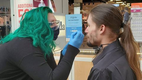 Zengota does a nose piercing on a customer at the Tacoma Mall.