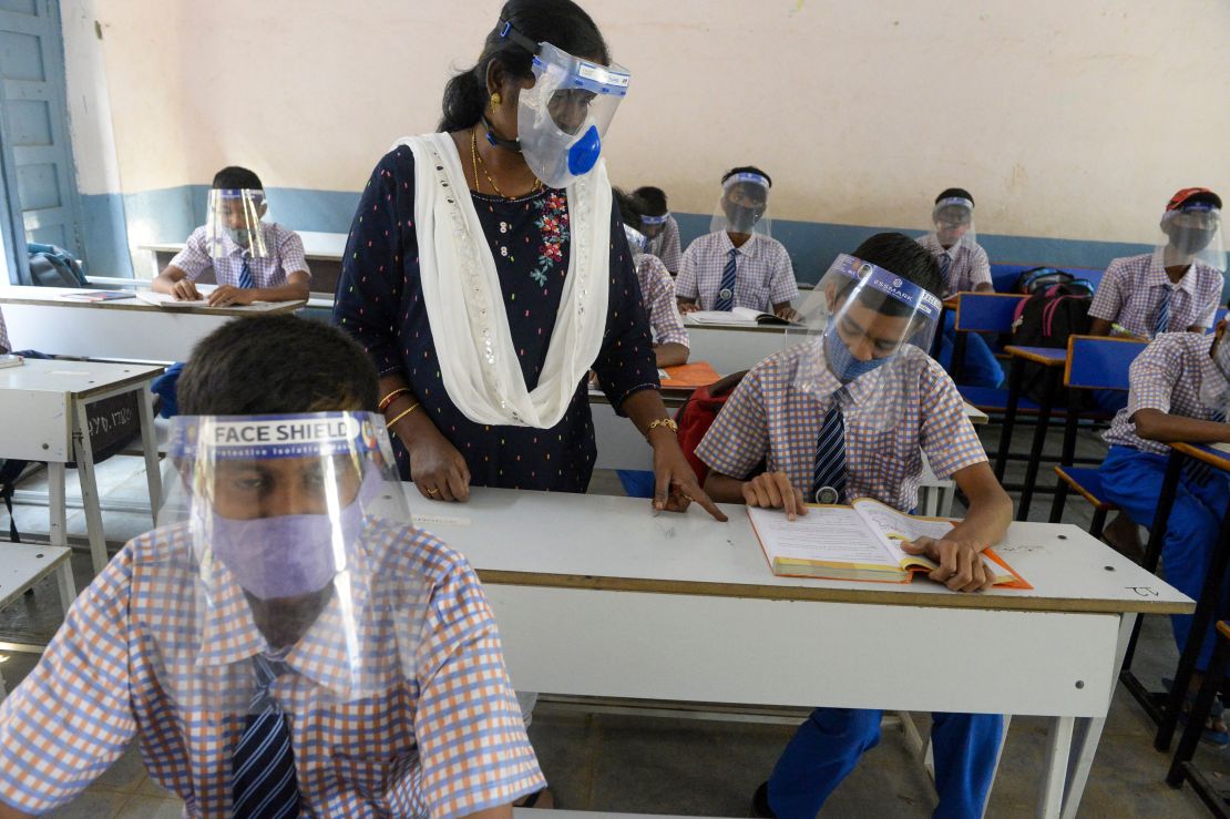 Students wearing face masks and face shields attend class in Hyderabad, India, on February 6, 2021.