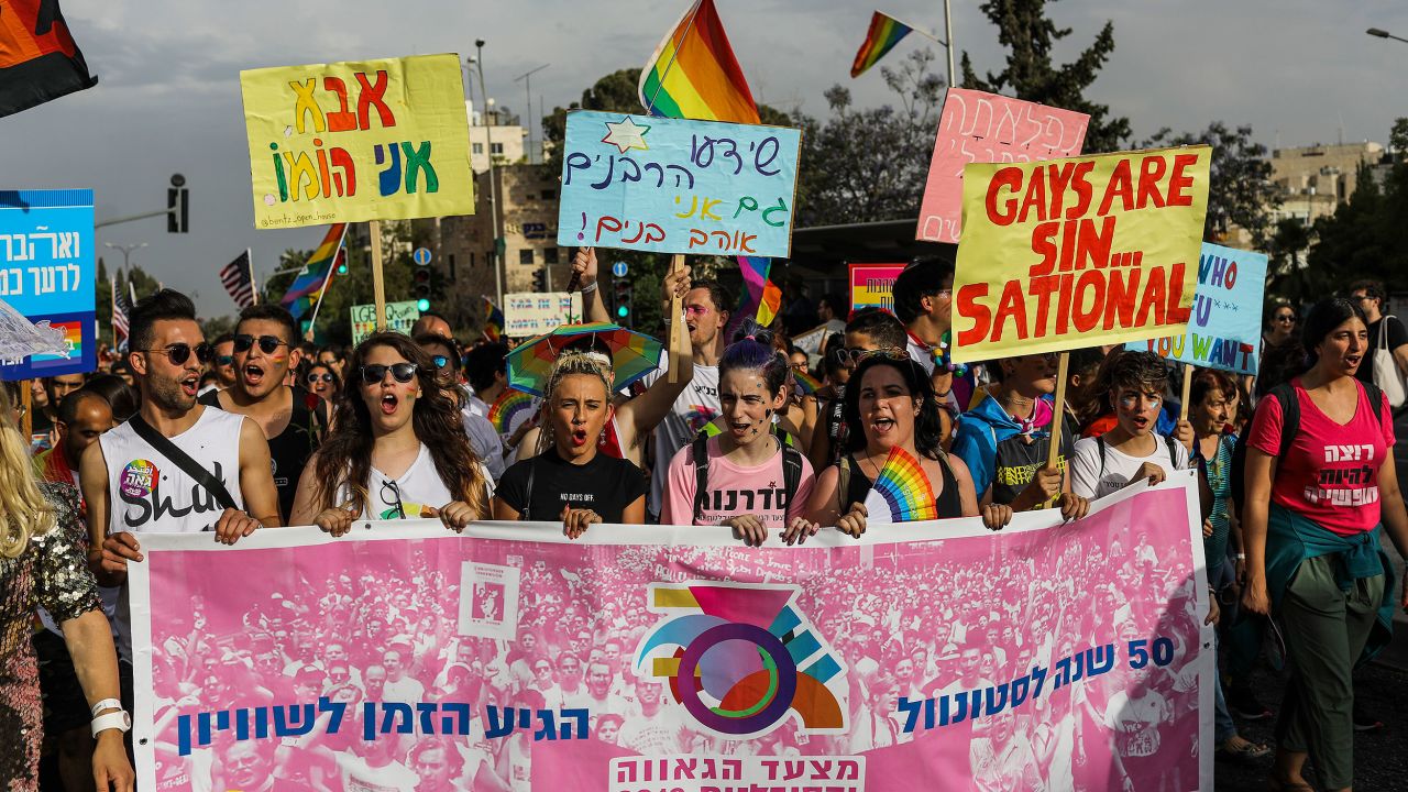 Participants hold placards and banners during the annual Gay Pride Parade in Jerusalem.