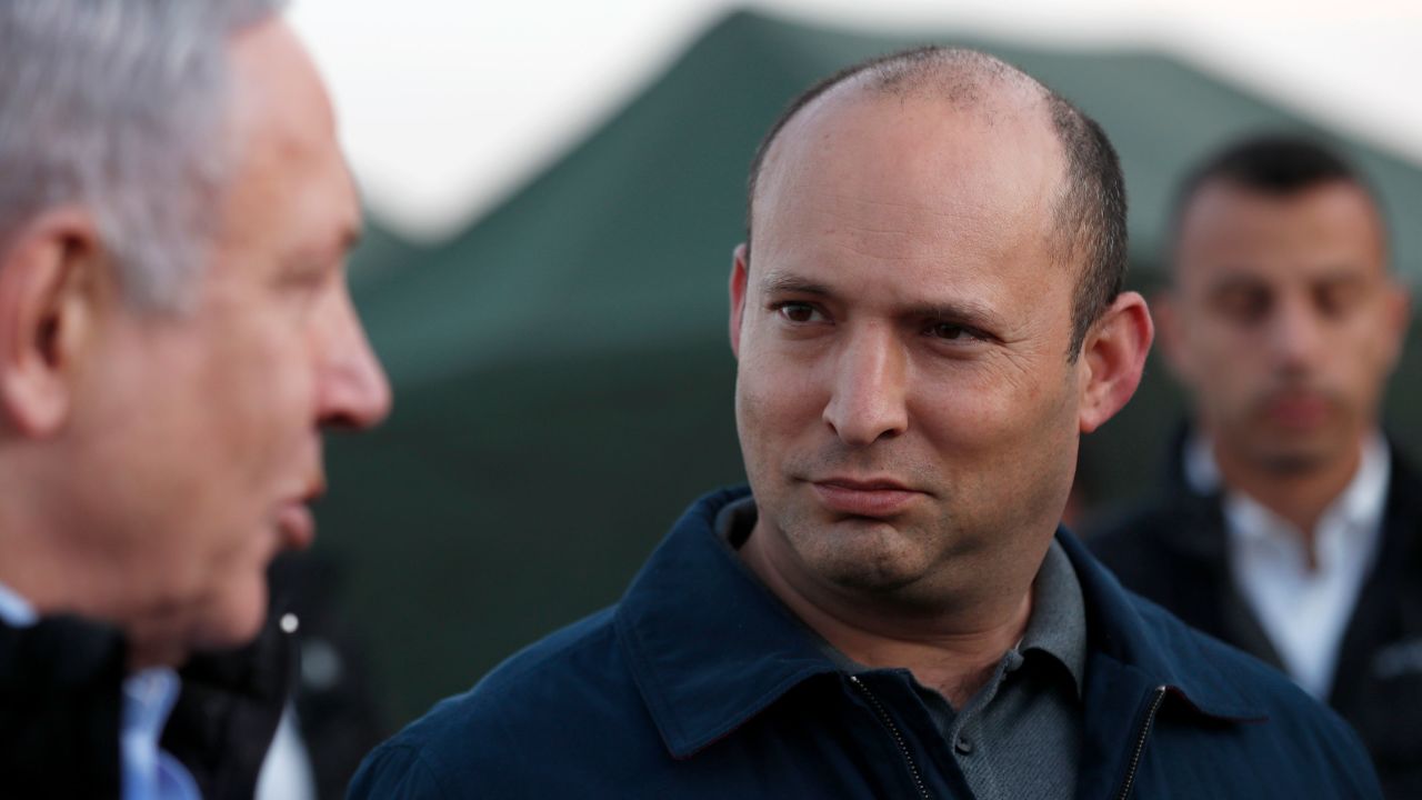 Israel's Prime Minister Benjamin Netanyahu and Defence Minister Naftali Bennett visit an army base in the Israeli-annexed Golan Heights overlooking Syrian territory, on November 24, 2019.