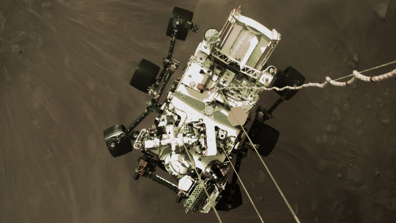 This shot from a camera on Perservance's "jetpack" captures the rover in midair, just before its wheels touched down.