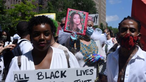 A person holds up a picture of Layleen Polanco, a transgender woman who died at the Rikers Island prison, during a Black Trans Lives Matter rally in New York City last summer.