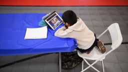 A child attends an online class at a learning hub inside the Crenshaw Family YMCA during the Covid-19 pandemic on February 17, 2021 in Los Angeles, California. While many area schools remain closed for in-person classes, the learning hub program provides structured distance education resources including free WiFi, electricity, staff support, academic tutoring, and recreation activities to provide a safe environment to support low income and minority communities. (Photo by Patrick T. Fallon/AFP/Getty Images)