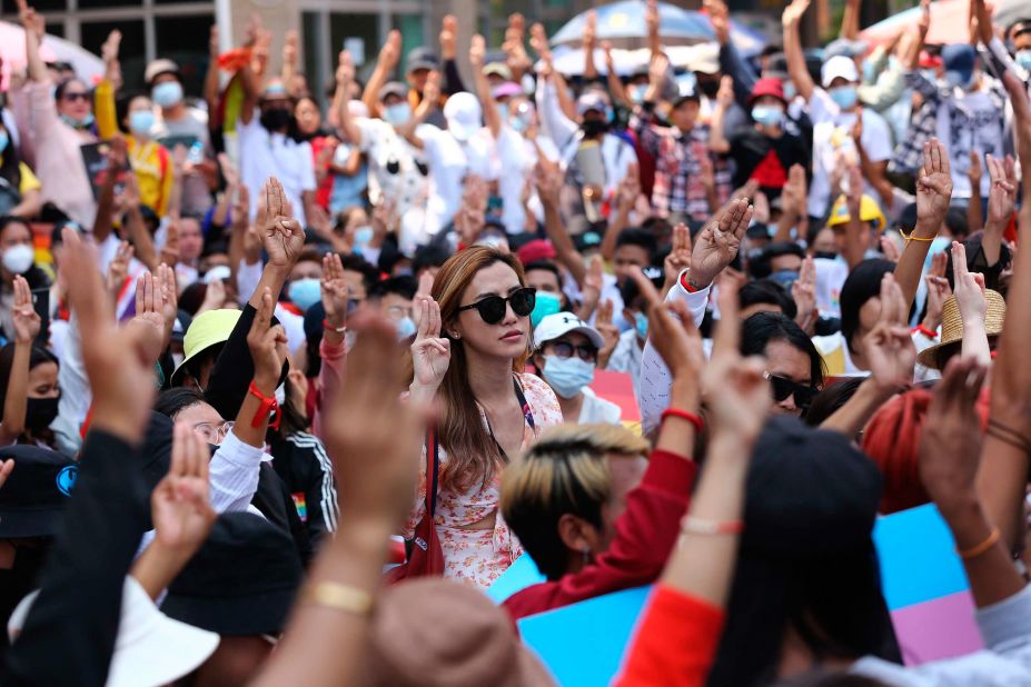 Protesters flash the three-fingered salute during a rally in downtown Yangon on February 19.