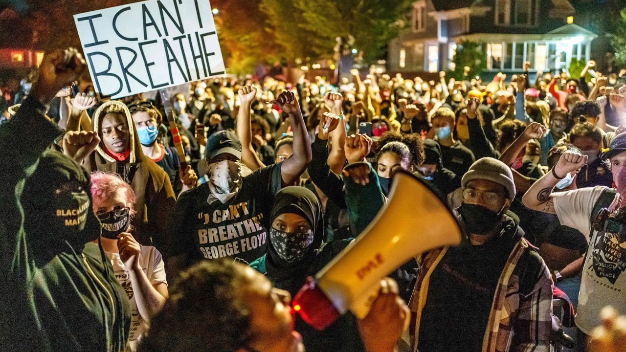 Protesters raise their fists during a demonstration after the release on bail of former police officer, Derek Chauvin, in Minneapolis, Minnesota, on October 7, 2020. Chauvin was charged in the death of George Floyd.