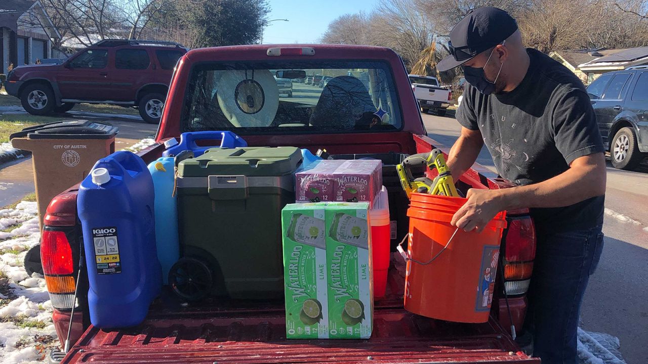 Texas Tribune Chief Creative Officer Jacob Villanueva loads water supplies into his truck in South Austin. He picked up a load of water at the home of Photo Editor Miguel Gutierrez Jr.