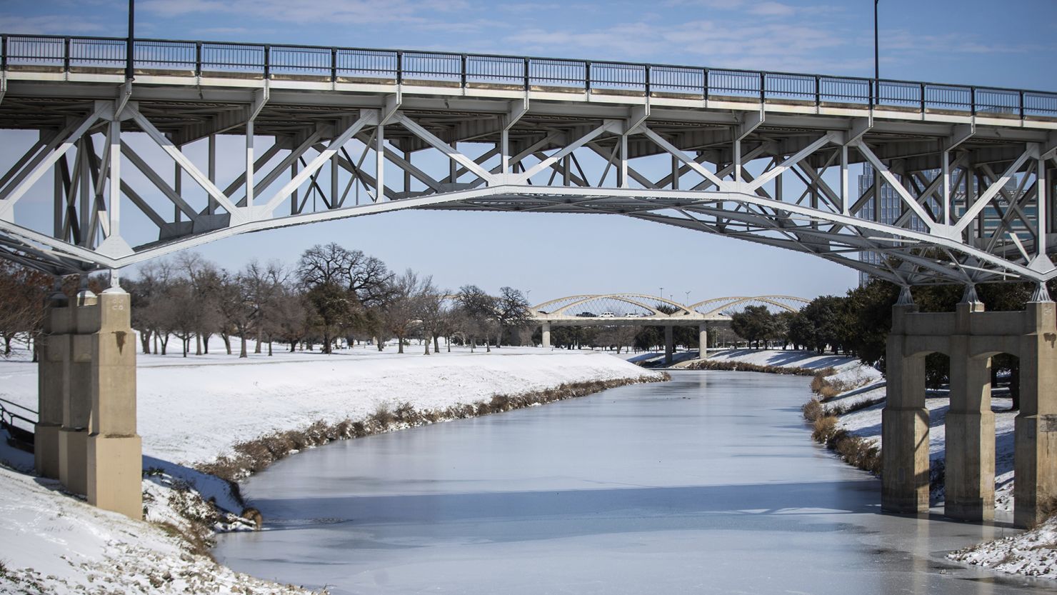 The Trinity River is mostly frozen after a snow storm Monday, Feb. 15, 2021, in Fort Worth, Texas.