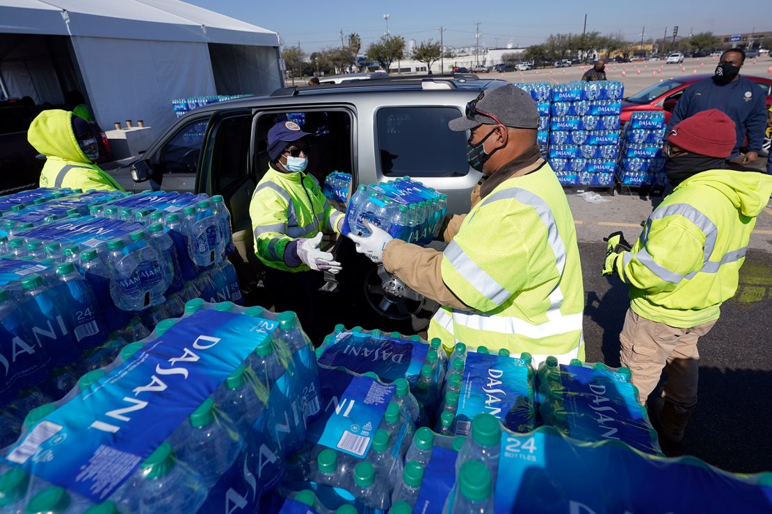 Bottled ater is loaded into a vehicle at a city of Houston water distribution site Friday. The location provided bottled water to residents in need while the city remains on a boil water notice.
