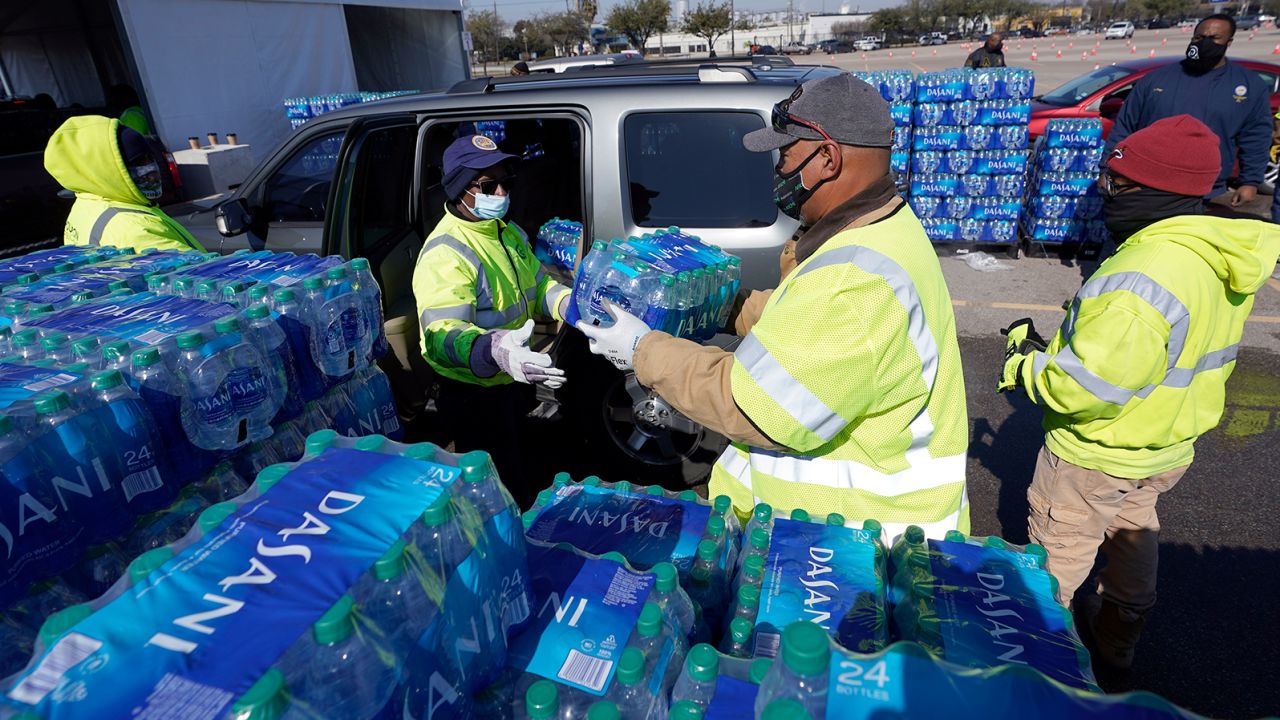 Bottled ater is loaded into a vehicle at a city of Houston water distribution site Friday. The location provided bottled water to residents in need while the city remains on a boil water notice.