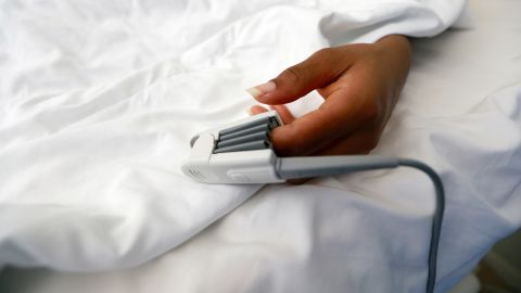 A pulse oximeter is attached to a patient's finger.
