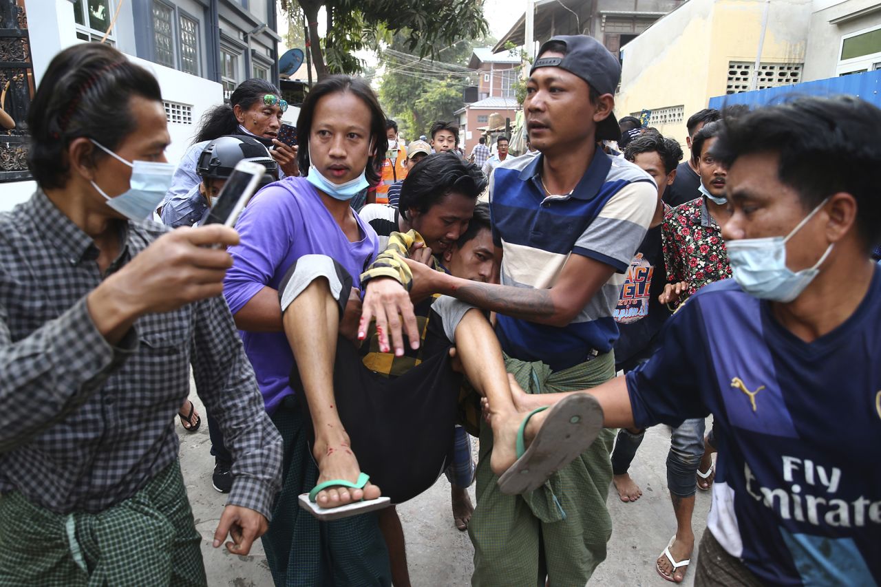A man is carried after police dispersed protesters in Mandalay on February 20. 