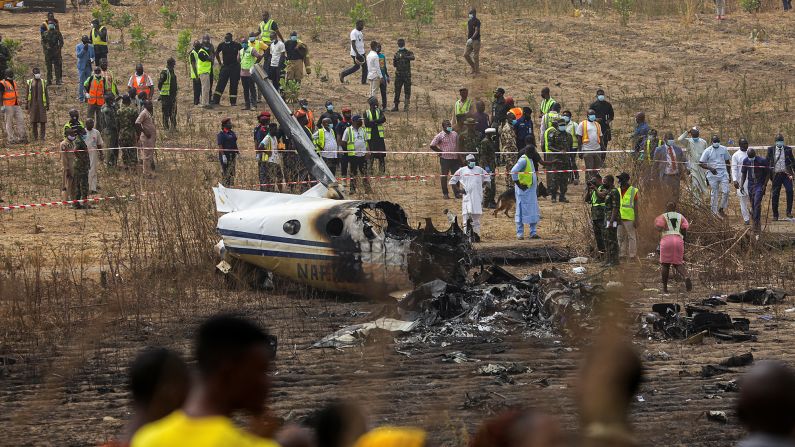 People gather at the site where <a href="https://www.cnn.com/2021/02/21/africa/nigeria-miliary-plane-crash-intl/index.html" target="_blank">a Nigerian military plane crashed</a> on its approach to the Abuja airport on Sunday, February 21. Seven people were killed.