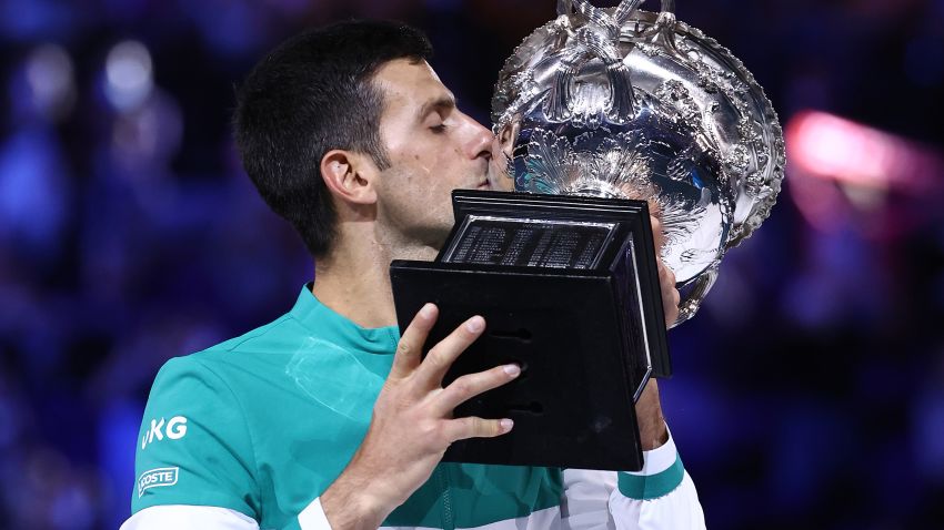 MELBOURNE, AUSTRALIA - FEBRUARY 21: Novak Djokovic of Serbia holds the Norman Brookes Challenge Cup as he celebrates victory in his Men's Singles Final match against Daniil Medvedev of Russia  during day 14 of the 2021 Australian Open at Melbourne Park on February 21, 2021 in Melbourne, Australia. (Photo by Cameron Spencer/Getty Images)