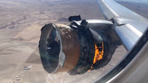 A video taken inside the plane by a passenger shows flames coming from the engine.