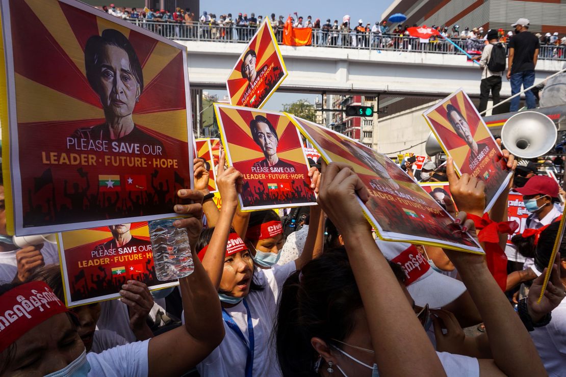 Protesters hold signs featuring Aung San Suu Kyi as they take part in a demonstration against the military coup in Yangon on February 22. 