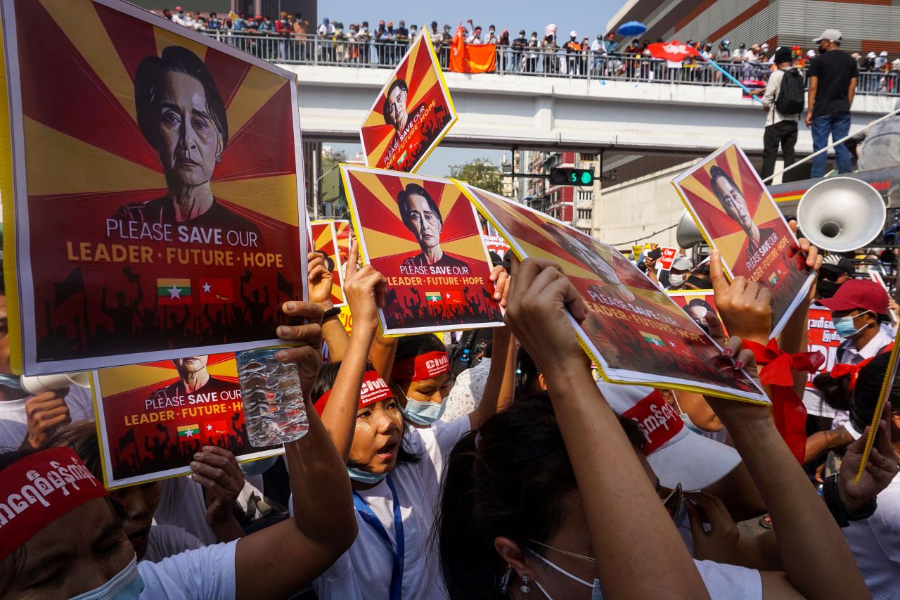 Protesters hold signs featuring civilian leader Aung San Suu Kyi during a demonstration in Yangon on February 22. 