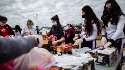 Texans Cheerleaders and other volunteers pack food to distribute to hundreds of people picking up supplies from their cars after frigid temperatures left the Houston area depleted of resources, Sunday, Feb. 21, 2021, in Houston.