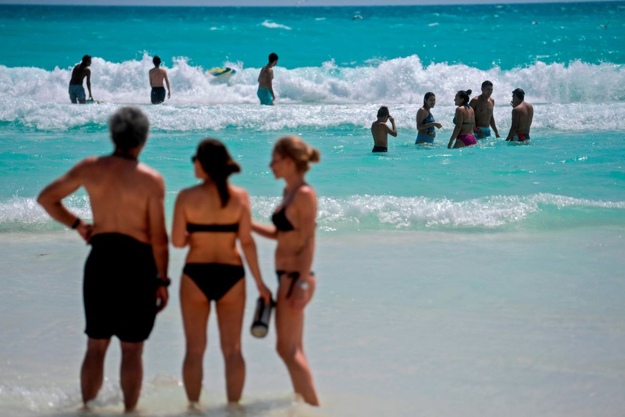 Mexico's international tourism income dropped by more than half in 2020. Here, people enjoy the beach in Cancun in October 2020. 