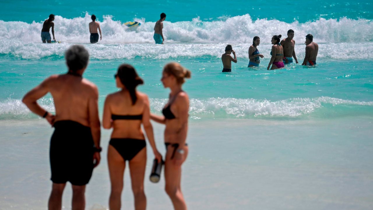 Mexico has been one of the easiest places to visit throughout the pandemic, but it's now at Level 4. Pictured: People enjoy the beach in Cancun on October 8, 2020.