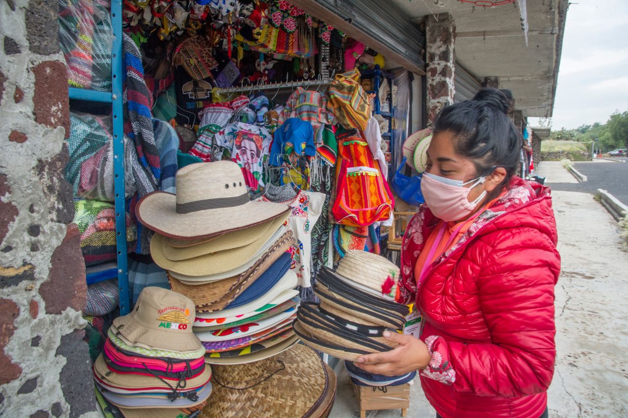 A handicrafts vendor puts hats on display at the archaeological site of Teotihuacan on September 10, 2020.