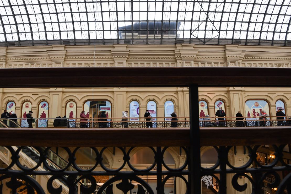 People line up to receive a shot of Sputnik V at a clinic in the GUM mall in Moscow.