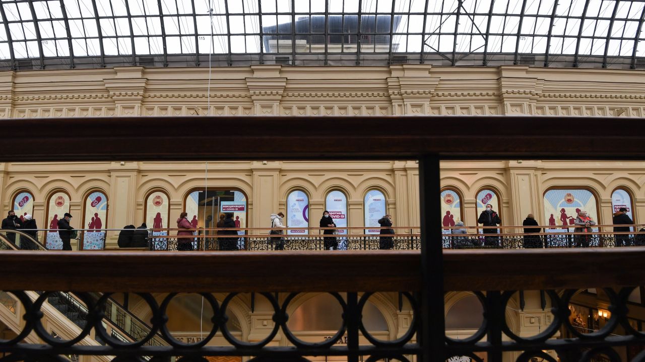 People line up to receive a shot of Sputnik V at a clinic in the GUM mall in Moscow.