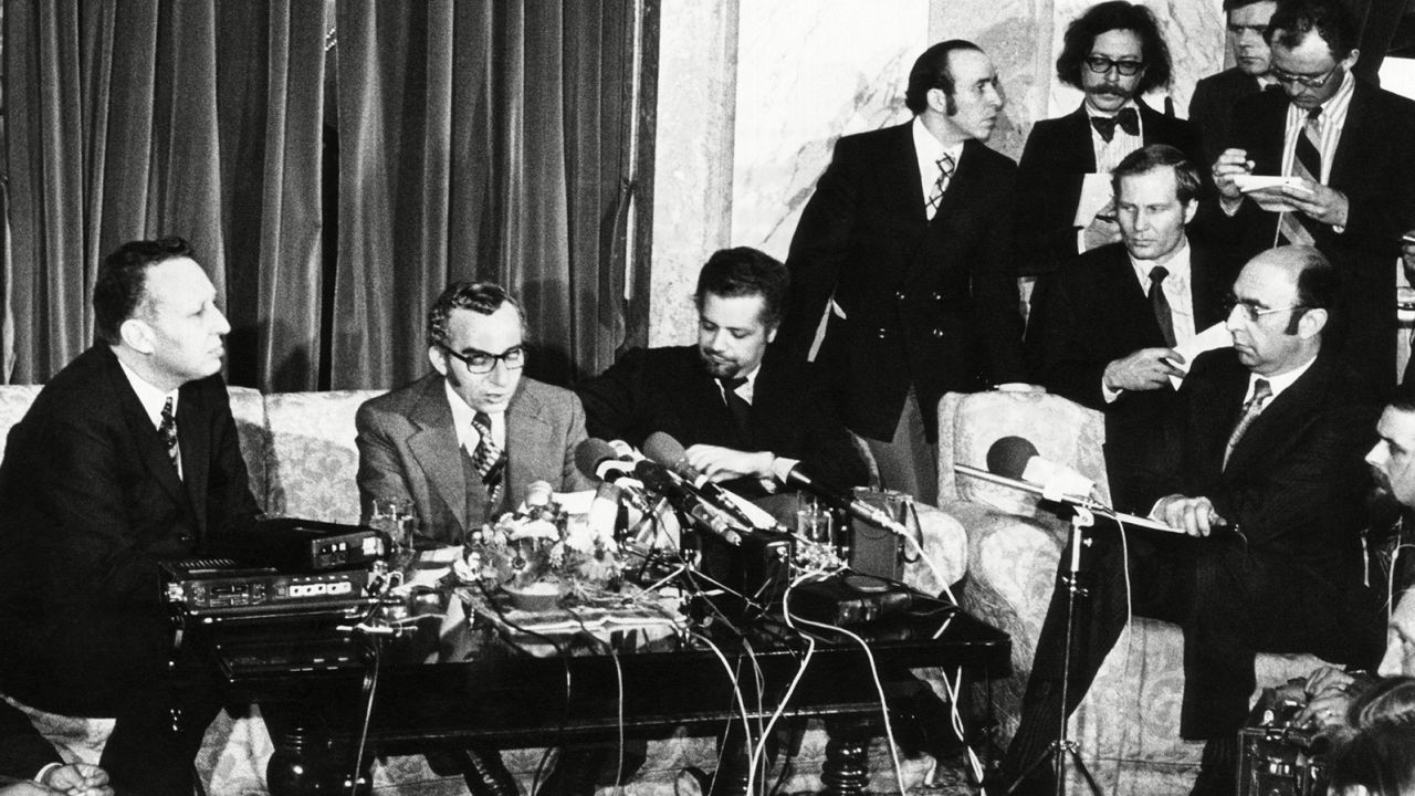 Oil ministers including Ahmed Zaki Yamani (seated, with moustache and beard) announce OPEC is lifting the oil embargo against the United States.