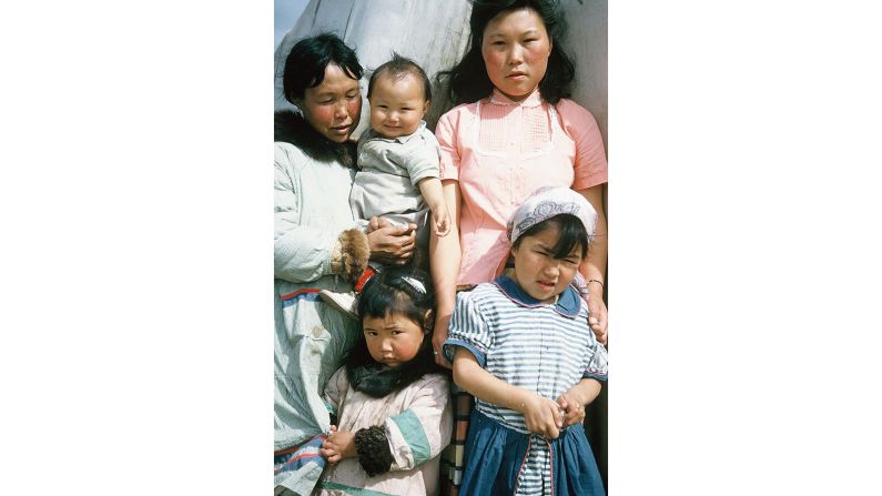 <strong>Delightful discovery: </strong>Abby Augustine recognized this photo. She's the baby in the image, held by her mother and surrounded by her sisters. "My daughter is super delighted to see a baby picture of me as we barely had any," she tells CNN.