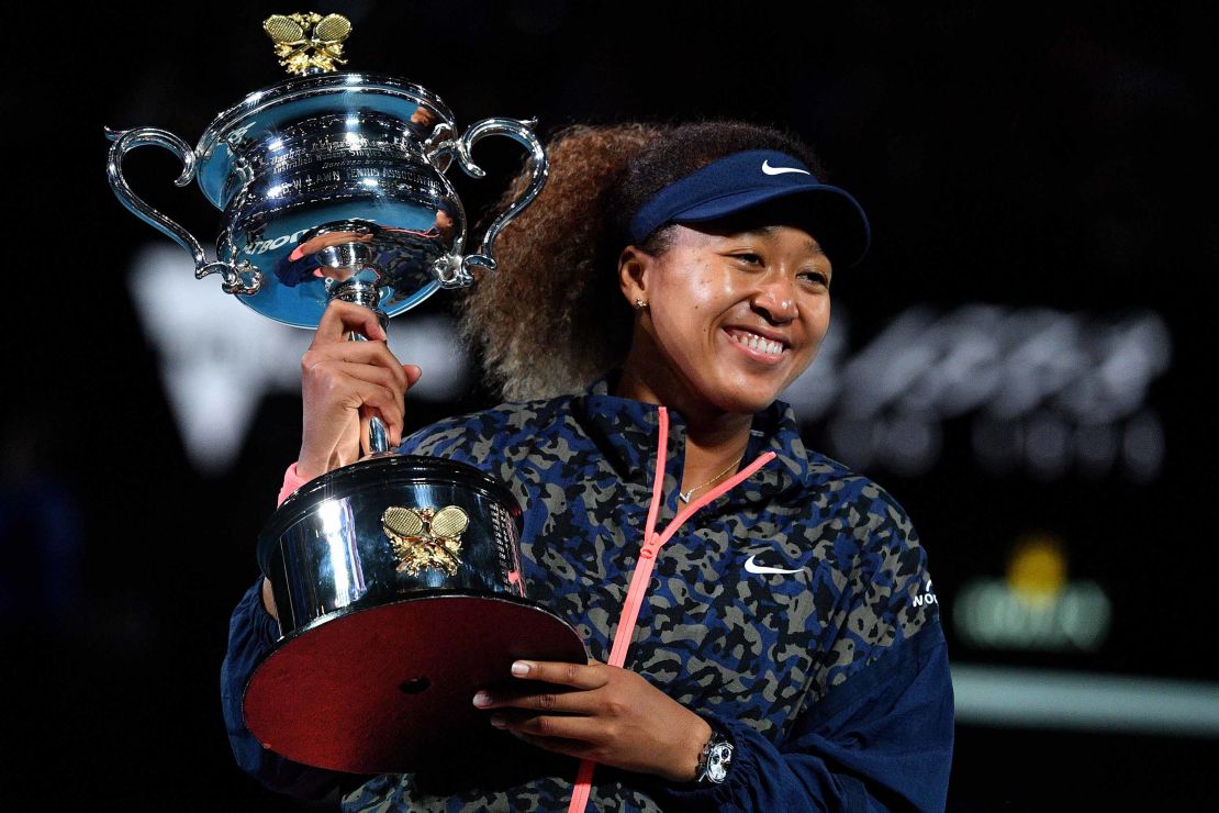 Naomi Osaka holds the Daphne Akhurst Memorial Cup trophy after beating Jennifer Brady of the US to win their women's singles final match at the 2021 Australian Open.