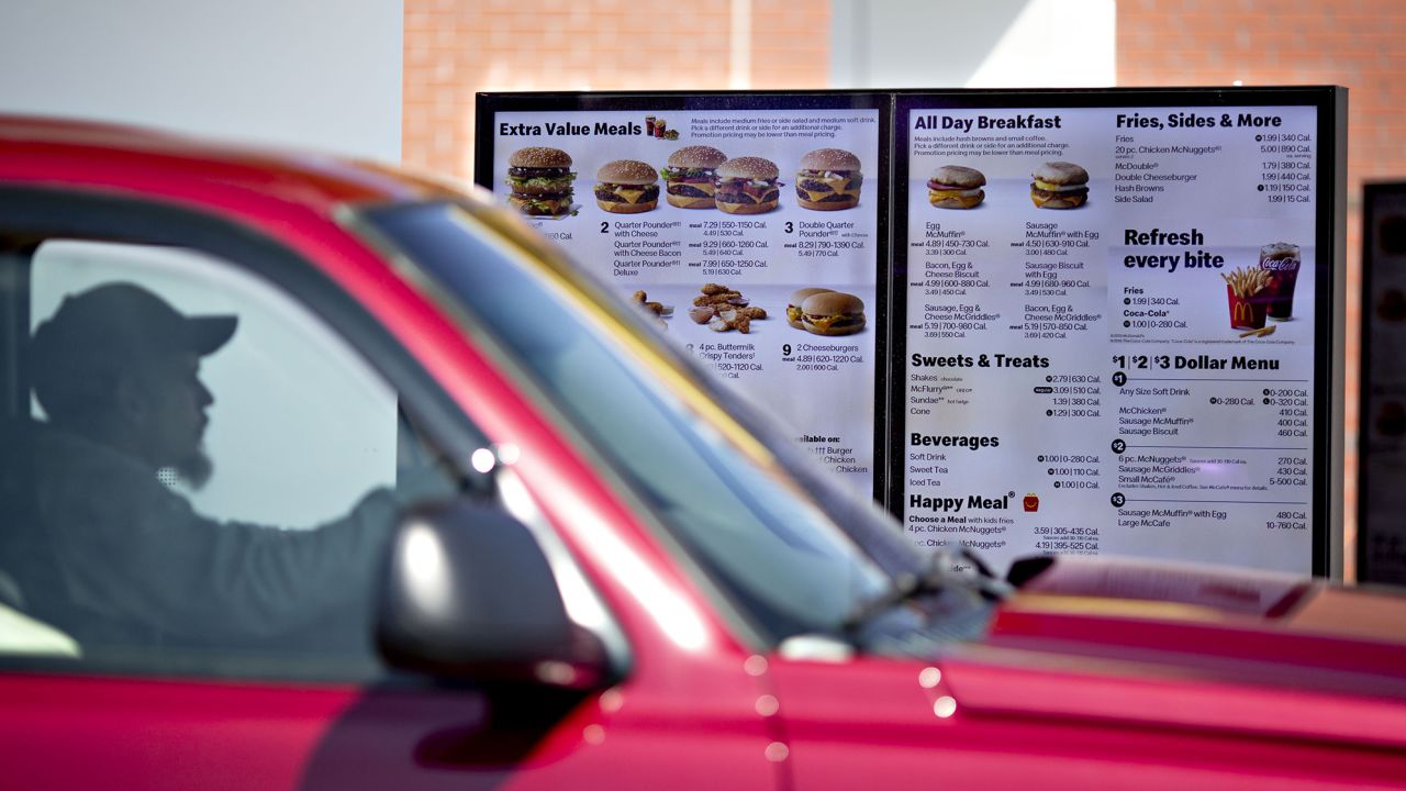 A customer views a digital menu at the drive-thru outside a McDonald's restaurant in Peru, Illinois.