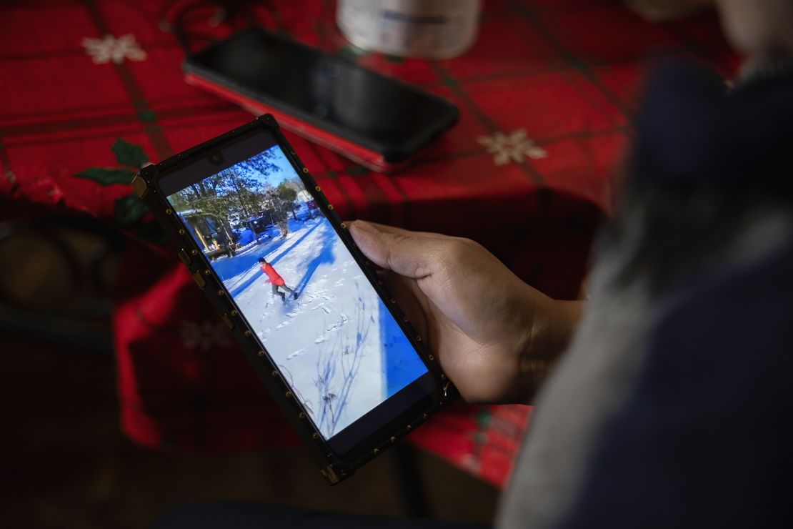 Maria Pineda watches a video of her son, Cristian Pavon Pineda, 11, playing in the snow for the first time on February 18 in Conroe, Texas.