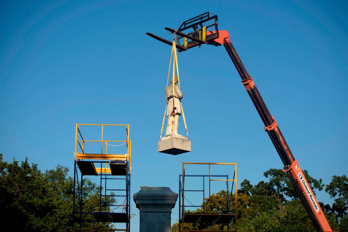 City workers remove a statue of Confederate soldier Dick Dowling from Hermann Park on June 17, 2020, in Houston, Texas.